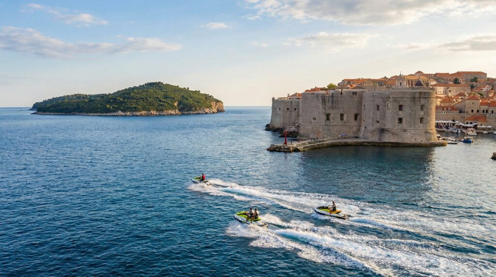 Jet skis riding past Dubrovnik Old Town city walls with Lokrum Island in the background – popular adventure activity for cruise visitors spending one day in Dubrovnik.