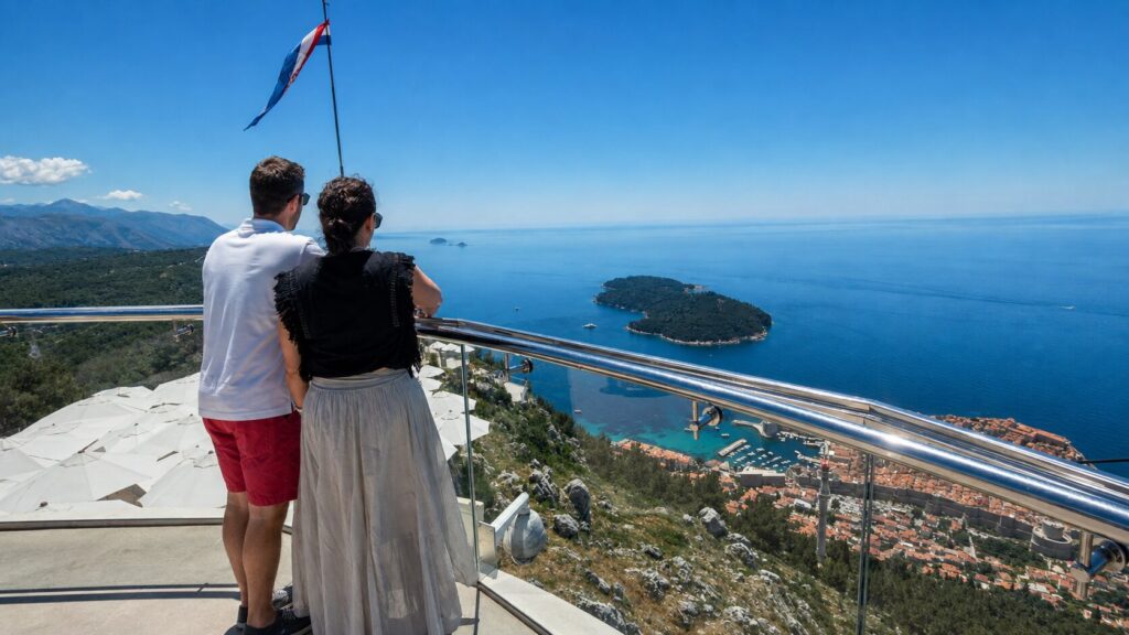 Couple enjoying panoramic views of Dubrovnik and Lokrum Island from Mount Srđ