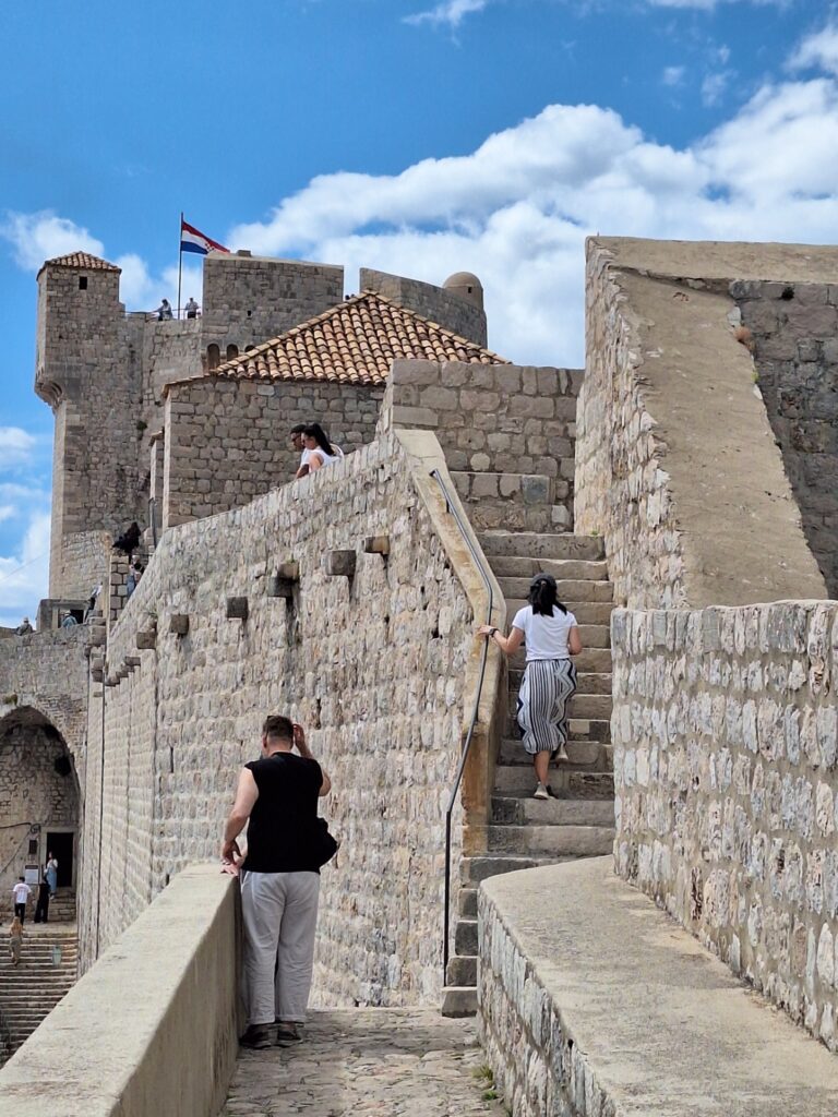 Visitors walking up stone stairs on the Dubrovnik City Walls in Dubrovnik Old Town