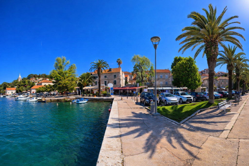 Cavtat harbor promenade with palm trees and Adriatic Sea near Dubrovnik