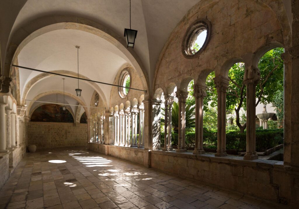 Cloister courtyard of the Dominican Monastery in Dubrovnik Old Town with Gothic arches and stone columns