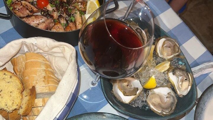 Black risotto and Adriatic seafood with oysters and Croatian red wine in Dubrovnik