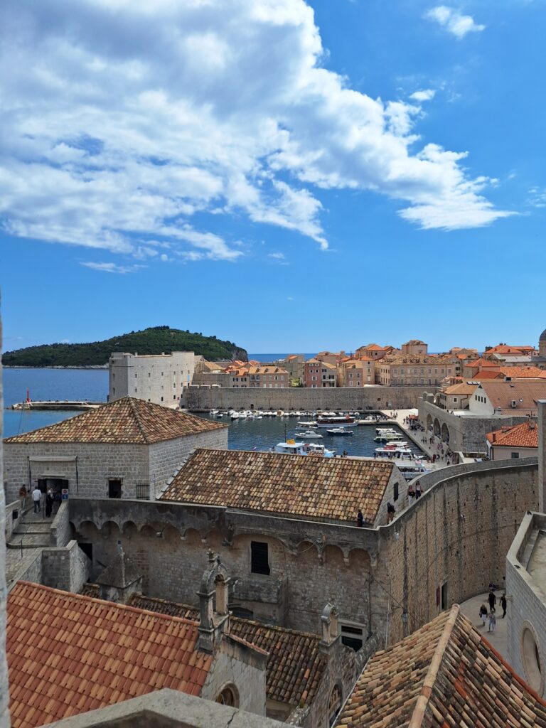 View of Dubrovnik Old Town harbor and city walls with Lokrum Island in the background, a highlight of many Dubrovnik walking tour itineraries.