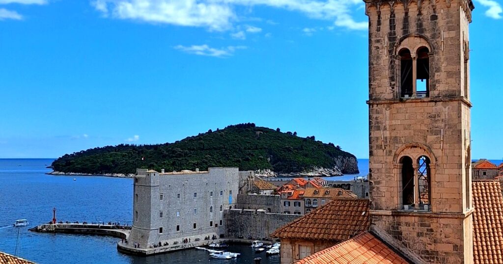 View of Dubrovnik Old Town harbor, bell tower and Lokrum island – starting point for Dubrovnik walking tours