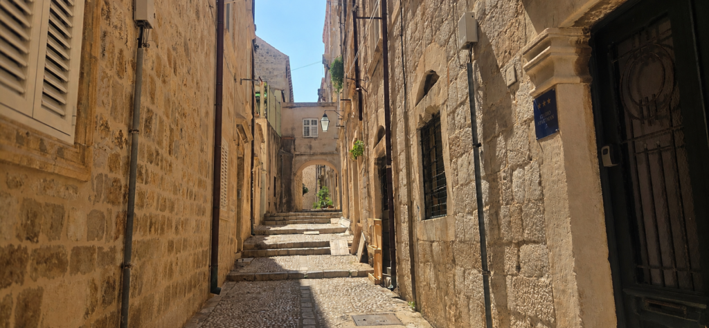 Quiet hidden street in Dubrovnik Old Town with historic stone houses and steps
