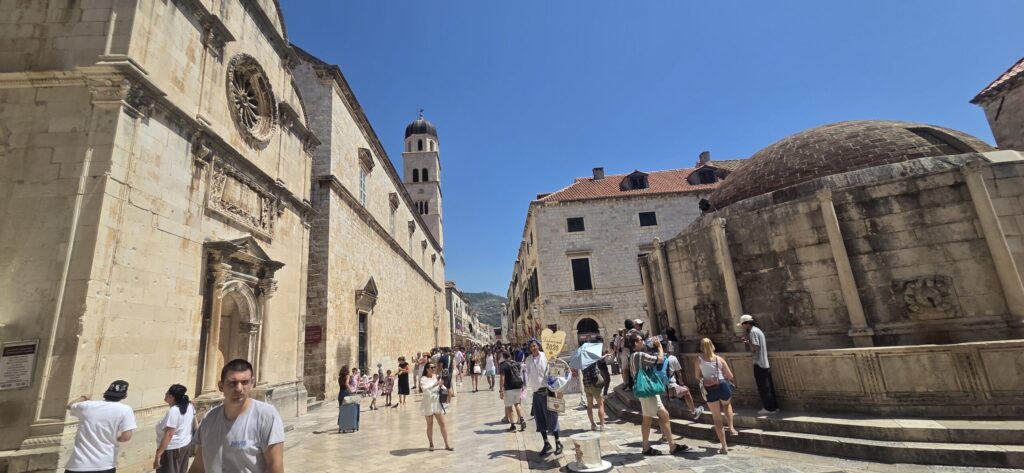 Stradun in Dubrovnik Old Town with historic stone buildings and people walking through the main street