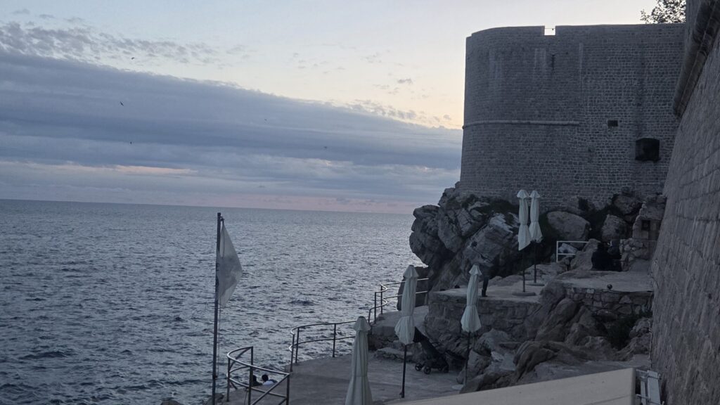 quiet corner near Dubrovnik city walls with sea view at sunset
