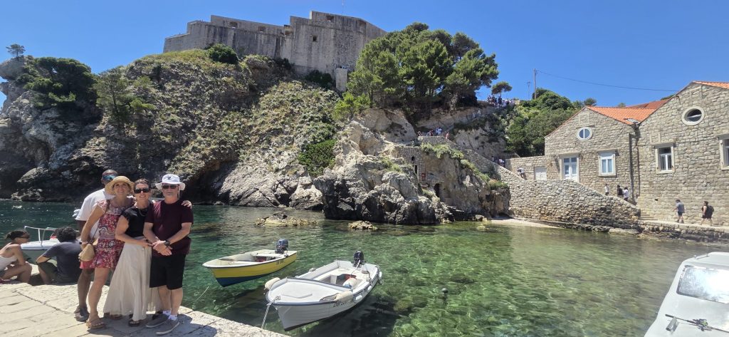 American cruise guests enjoying a scenic photo stop near Dubrovnik's Old Harbor during a private shore excursion.