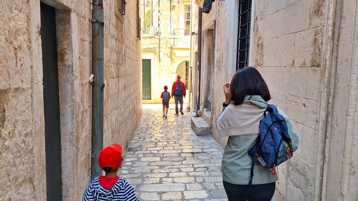 family walking through a quiet street in Dubrovnik old town