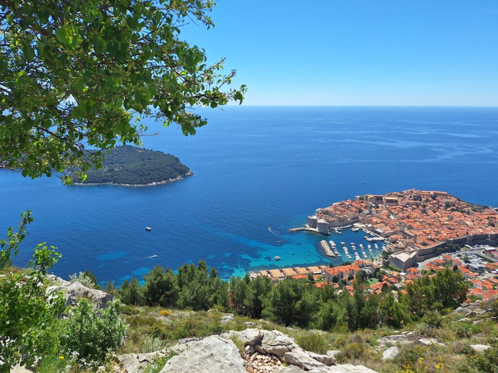 Panoramic view above Dubrovnik overlooking the Old Town, Lokrum Island, Adriatic Sea, and surrounding coastline from the hills above the city.