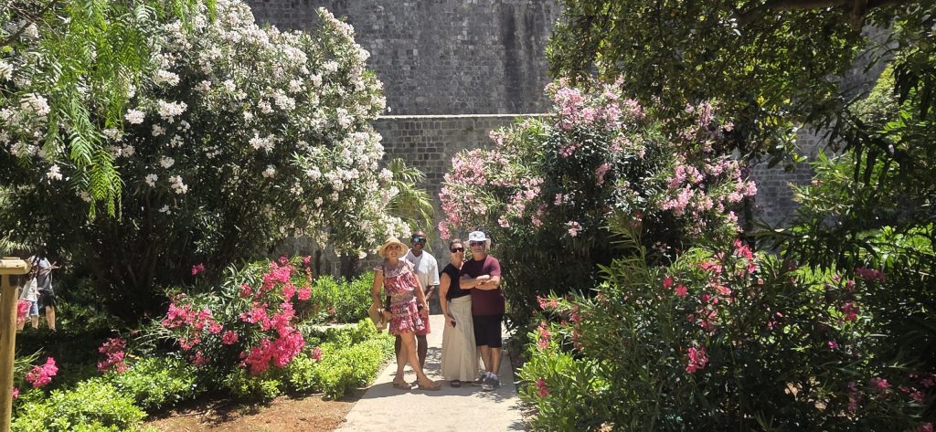 American cruise guests exploring a peaceful garden corner inside Dubrovnik's Old Town during a private shore excursion.