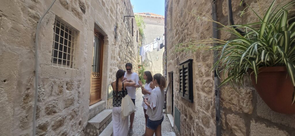Laundry drying outside between stone houses in a hidden street of Dubrovnik Old Town