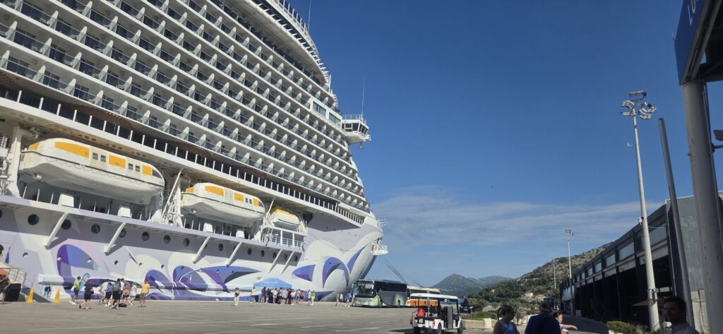 Cruise ship at Dubrovnik Cruise Port with buses and passengers preparing transport to the Old City.