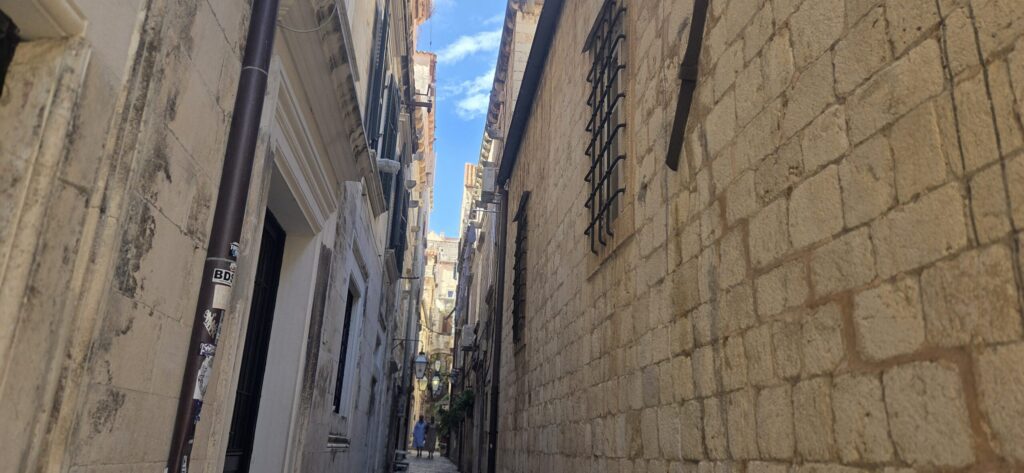 Quiet hidden street in Dubrovnik Old City showing local atmosphere away from the main tourist route.