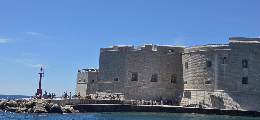 Dubrovnik Old Port and city walls seen from the sea, a useful local tip stop for cruise ship guests visiting the Old City.