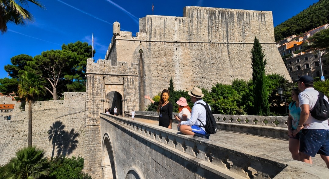 Private local guide in Dubrovnik showing guests Ploče Gate and the eastern entrance to the Old City during a private walking tour.