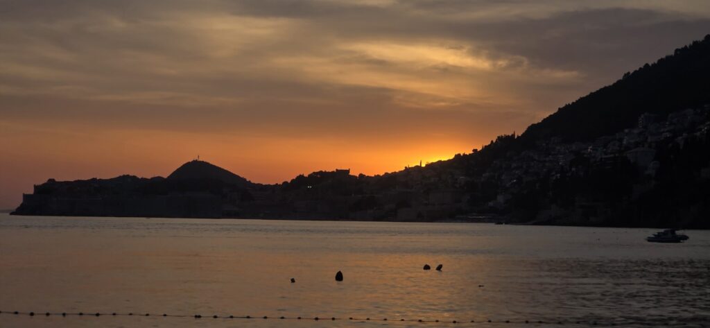 Sunset from Banje Beach with Dubrovnik Old Town silhouetted across the sea