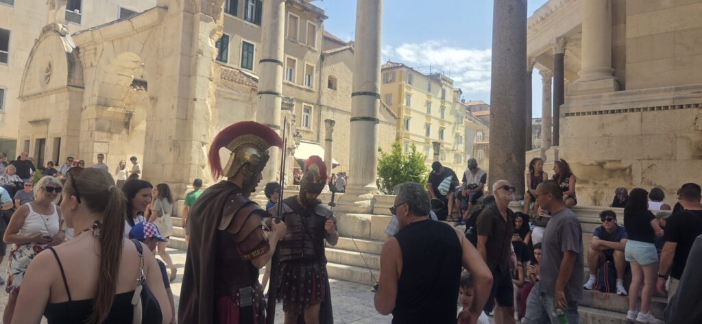 Diocletian’s Palace in Split with Roman-style performers, ancient columns and visitors in the Old Town