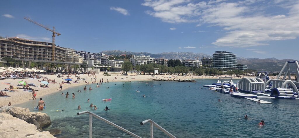 Split beach with people swimming in the clear Adriatic Sea near the city
