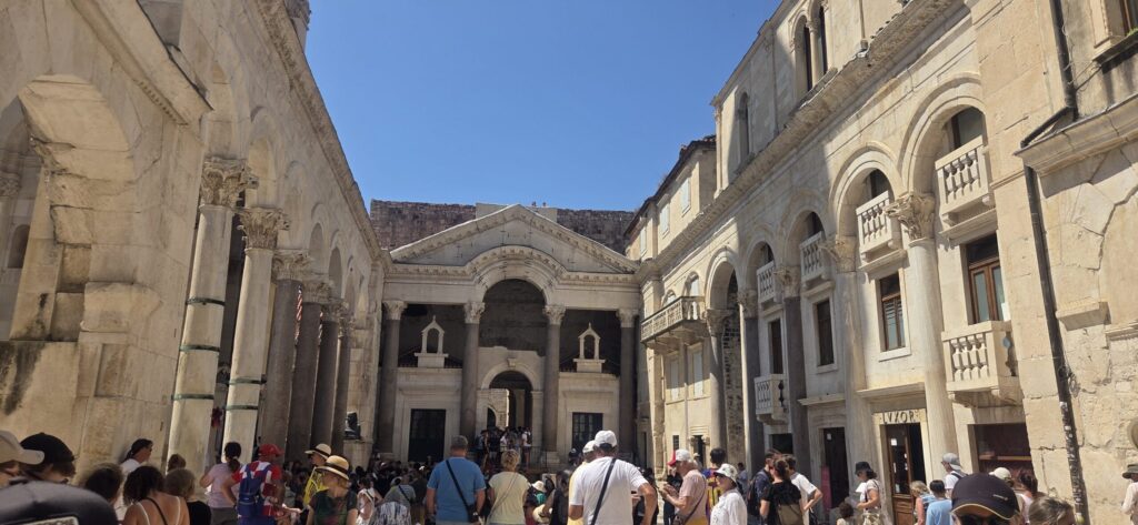 Diocletian’s Palace in Split with Roman columns, historic stone buildings and visitors walking through the Old Town