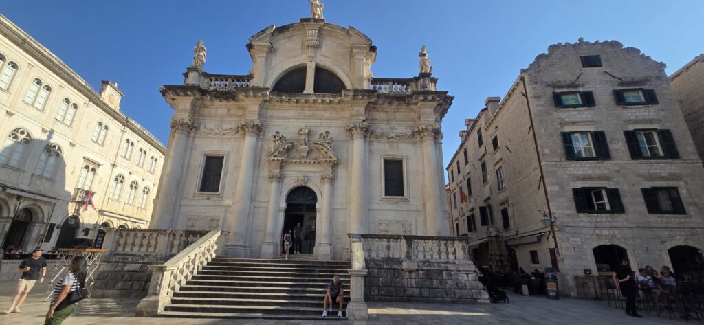 Church of St Blaise in Luža Square, Dubrovnik, viewed from Stradun with its Baroque façade and entrance steps.