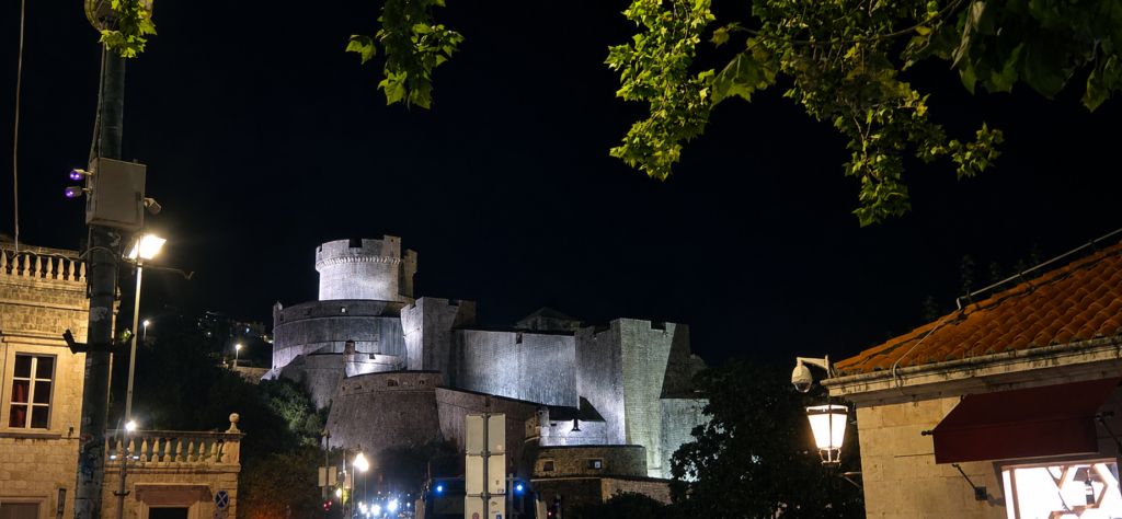 Dubrovnik City Walls illuminated at night above Pile Gate