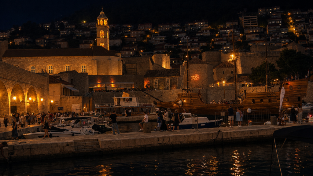 Dubrovnik Old Port at night with boats and illuminated historic walls