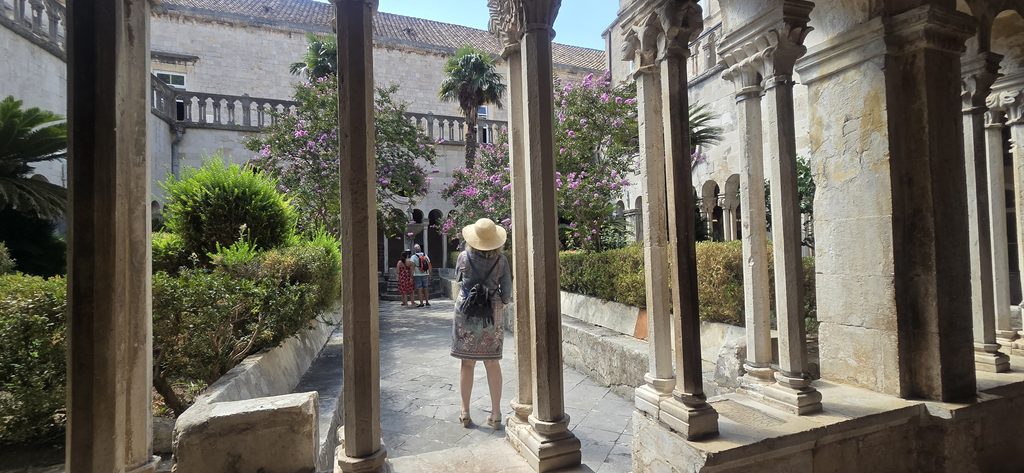 
Senior visitor walking through the Franciscan Monastery cloister in Dubrovnik