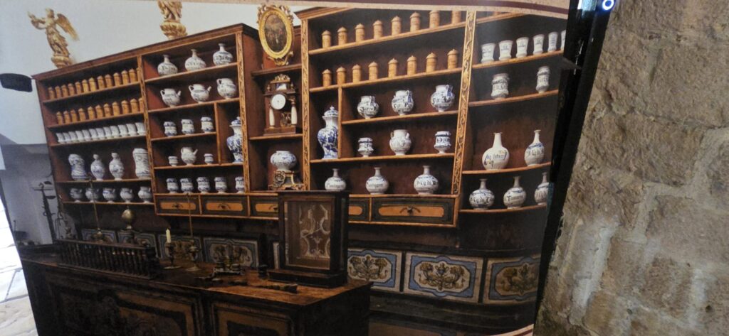 Historic pharmacy display with ceramic medicine jars inside the Franciscan Monastery in Dubrovnik Old Town.