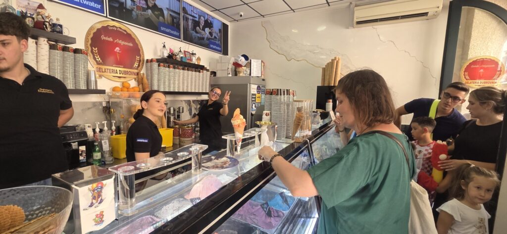 Customers ordering handmade gelato inside Gelateria Dubrovnik on Stradun, a family-run shop operating since 1968.