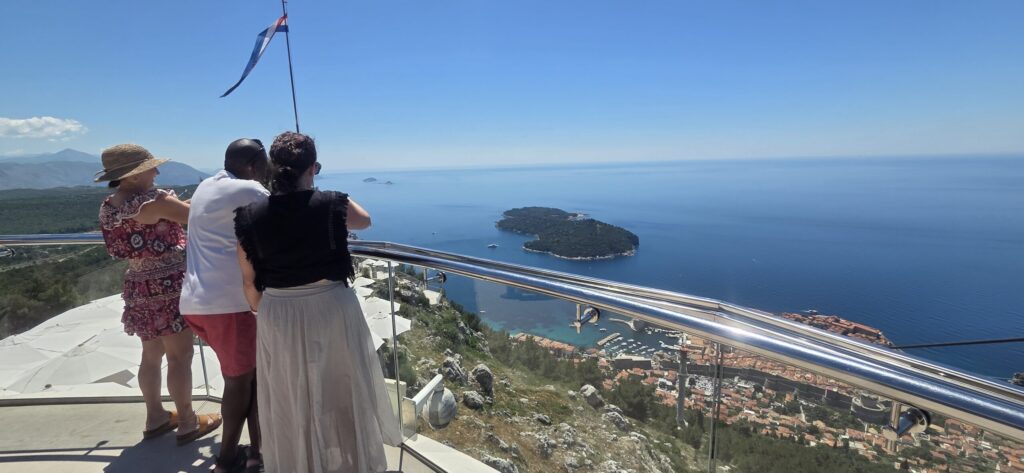 Visitors enjoying the panoramic view of Dubrovnik and Lokrum Island from Mount Srđ